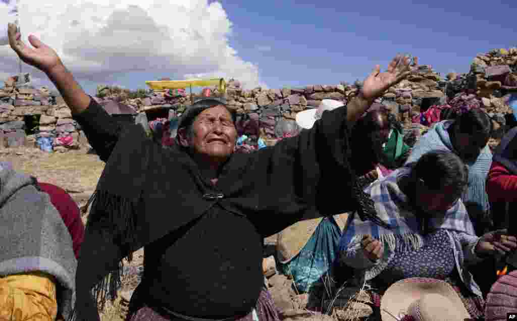 Aymara Indigenous women pray for rain on a day of fasting on the sacred Inca Pucara mountain in Chiquipata, Bolivia.