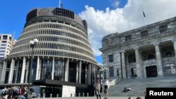 FILE - New Zealand's flags fly at half mast outside parliamentary buildings following the death of Queen Elizabeth, in Wellington, New Zealand, Sept. 8, 2022. 