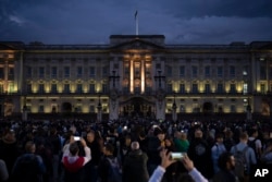 FILE - People gather outside Buckingham Palace in London, Friday, September 9, 2022 following the death of Queen Elizabeth II, Britain's longest-reigning monarch, the day before. (AP Photo/Felipe Dana)