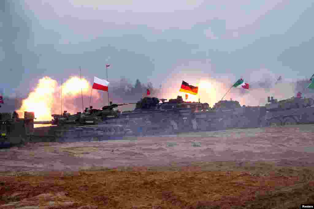 Polish PT-91 Twardy, German Leopard 2 and Italian Ariete tanks of NATO Enhanced Forward Presence battle groups attend live fire exercise, during Iron Spear 2022 military drill in Adazi, Latvia, Nov. 15, 2022.