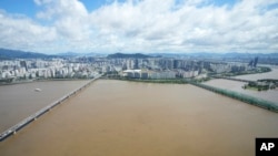 The Han River, swollen with floodwater, flows under bridges in Seoul, South Korea, Sept. 6, 2022. 