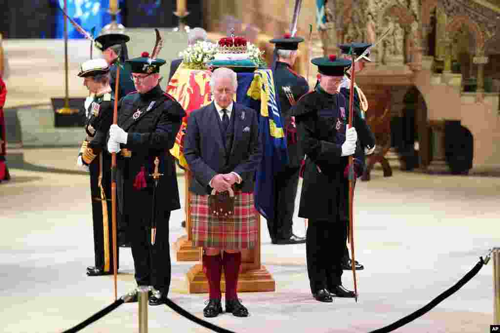 Britain&#39;s King Charles III, center, and other members of the royal family hold a vigil at the coffin of Queen Elizabeth II at St. Giles&#39; Cathedral, Edinburgh, Scotland, as members of the public walk past.