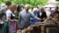 FILE - Britain's Prince Charles, Prince of Wales, center, looks at regional products as he visits the organic farm Herrmannsdorfer Landwerkstaetten in Glonn, southern Germany, on May 10, 2019.