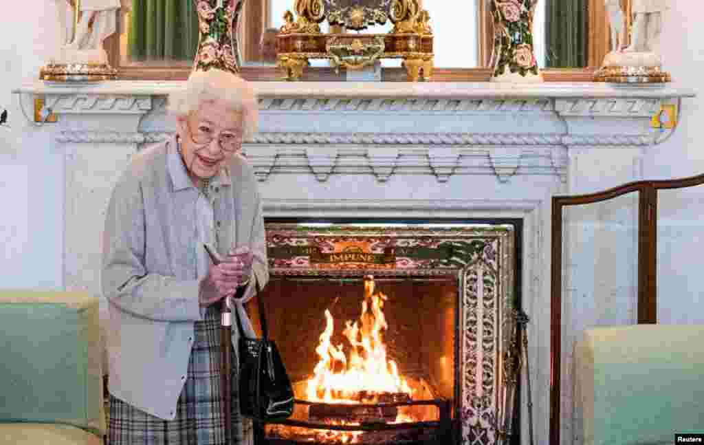 Queen Elizabeth waits in the Drawing Room before receiving Liz Truss, the newly elected leader of the Conservative Party and prime minister, at Balmoral Castle, Scotland, Sept. 6, 2022.