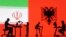 Figurines with computers are seen in front of Iranian and Albanian flags in this photo illustration created Sept. 10, 2022. 