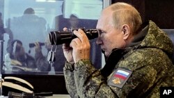 Russian President Vladimir Putin watches the Vostok 2022 military exercise in far eastern Russia, outside Vladivostok, Sept. 6, 2022.