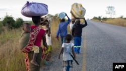 FILE — Displaced families from the community of Impire, a town in Mozambique's district of Metuge in the Cabo Delgado province, flee armed insurgents who attacked their community on June 12th, 2022. 