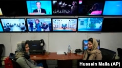 Afghan journalists Banafsha Binesh,and Wheeda Hassan at TOLO TV newsroom in Kabul, Afghanistan, Tuesday, Feb. 8, 2022. 