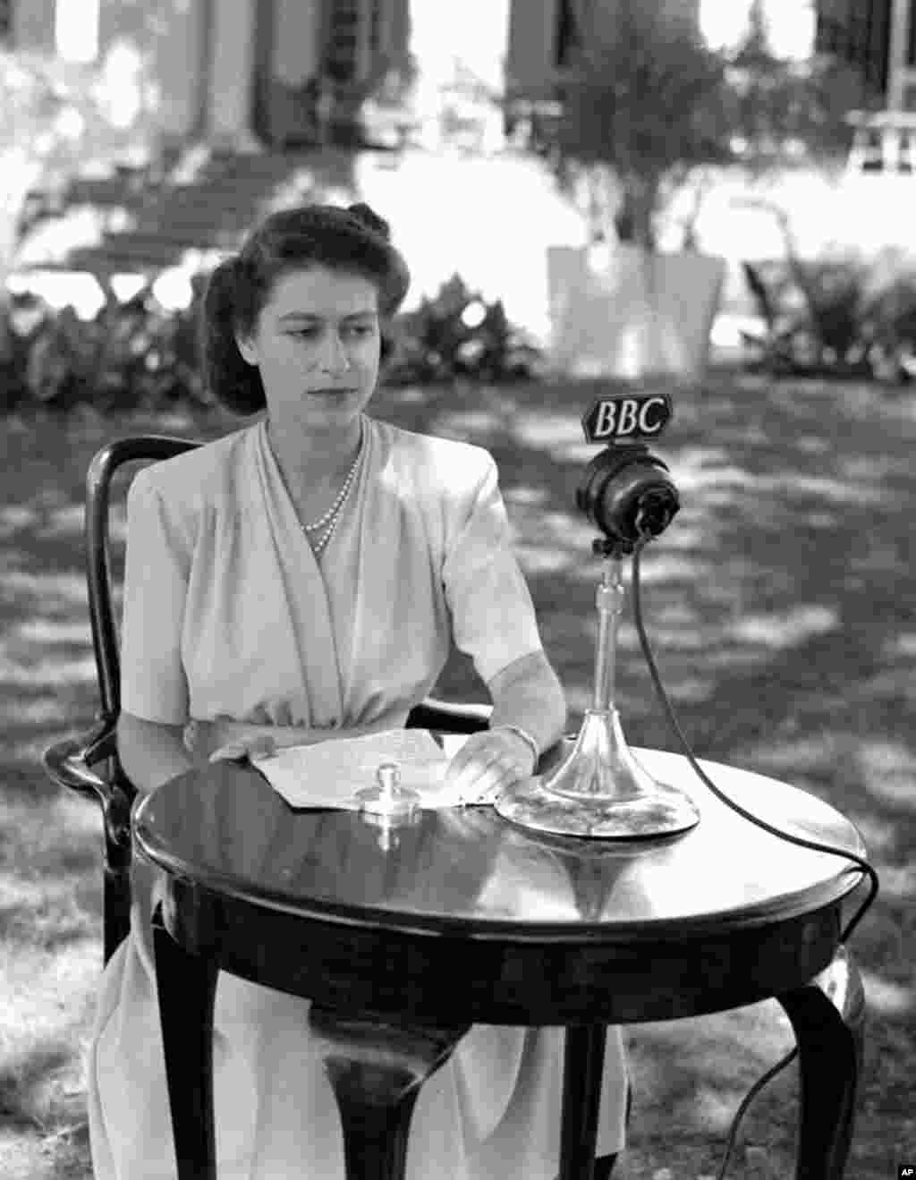 Specially posed portrait of HRH Princess Elizabeth, later Queen Elizabeth II, before the microphone for her 21st Birthday speech, April 21, 1947, which she made from Cape Town, South Africa. (AP Photo)