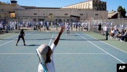 James Duff, bottom, serves during a tennis match between fellow San Quentin State Prison inmates and visiting players in San Quentin, Calif., Aug. 13, 2022.