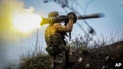 A Ukrainian soldier fires an anti-tank missile from an undisclosed location in the Donetsk region, Ukraine, Nov. 17, 2022.