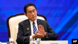 Japanese Prime Minister Fumio Kishida applauds in the APEC Leader's Dialogue with APEC Business Advisory Council, the part of the Asia-Pacific Economic Cooperation APEC summit, Nov. 18, 2022, in Bangkok, Thailand.