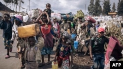 FILE - War-displaced people flee towards the city of Goma, eastern Republic of Congo, Nov. 15, 2022. 