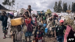 FILE - War-displaced people flee towards the city of Goma, eastern Republic of Congo, Nov. 15, 2022. More than 130 armed groups operating in the eastern Democratic Republic of Congo are creating havoc and terrorizing the population with their brutal, frequent attacks.