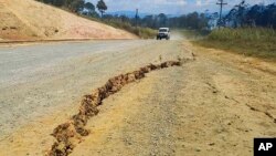A large crack is seen in a highway near the town of Kainantu, following a 7.6 magnitude earthquake in northeastern Papua New Guinea, Sept. 11, 2022. 