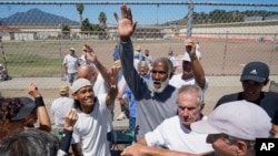 San Quentin State Prison inmates and a group of visiting players break a huddle after playing tennis together in San Quentin, Calif., Aug. 13, 2022.