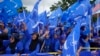 Supporters of Malaysia's Barisan Nasional coalition wave flags outside the nomination center ahead of elections, in Langkawi Island, Malaysia, Nov. 5, 2022. 