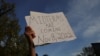 A demonstrator holds a sign reading "Midterms are Coming Nov 8, 2022" during a protest in support of abortion rights in front of the Massachusetts State House in Boston, May 3, 2022.