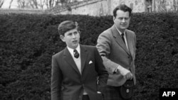 FILE - Britain's Prince Charles seen with Scottish businessman Iain Tennant on his first day at Gordonstoun school in Elgin, May 1, 1962. (Photo by PNA / AFP)