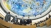 Delegates stand for a minute of silence for Britain's Queen Elizabeth, following her death, during the Human Rights Council in Geneva, Sept. 12, 2022. Picture taken with a fish-eye lens. 