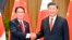 Perdana Menteri Jepang Fumio Kishida (kiri), dan Presiden China Xi Jinping berjabat tangan di sela-sela forum Kerja Sama Ekonomi Asia-Pasifik di Bangkok, , 17 November 2022. (Kyodo via AP)