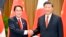Japanese Prime Minister Fumio Kishida, left, and Chinese President Xi Jinping shake hands during their meeting on the sidelines of the Asia-Pacific Economic Cooperation forum, Nov. 17, 2022, in Bangkok.