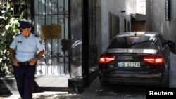 A police officer stands in front of the Embassy of the Islamic Republic of Iran as Albania cuts ties with Iran and orders diplomats to leave over cyberattack, in Tirana, Albania, Sept. 7, 2022.