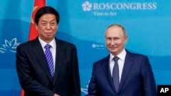 FILE - Russian President Vladimir Putin, right, and Chairman of National People's Congress Li Zhanshu pose for a photo prior to their talks on the sideline of the Eastern Economic Forum in Vladivostok, Russia, Sept. 7, 2022. 