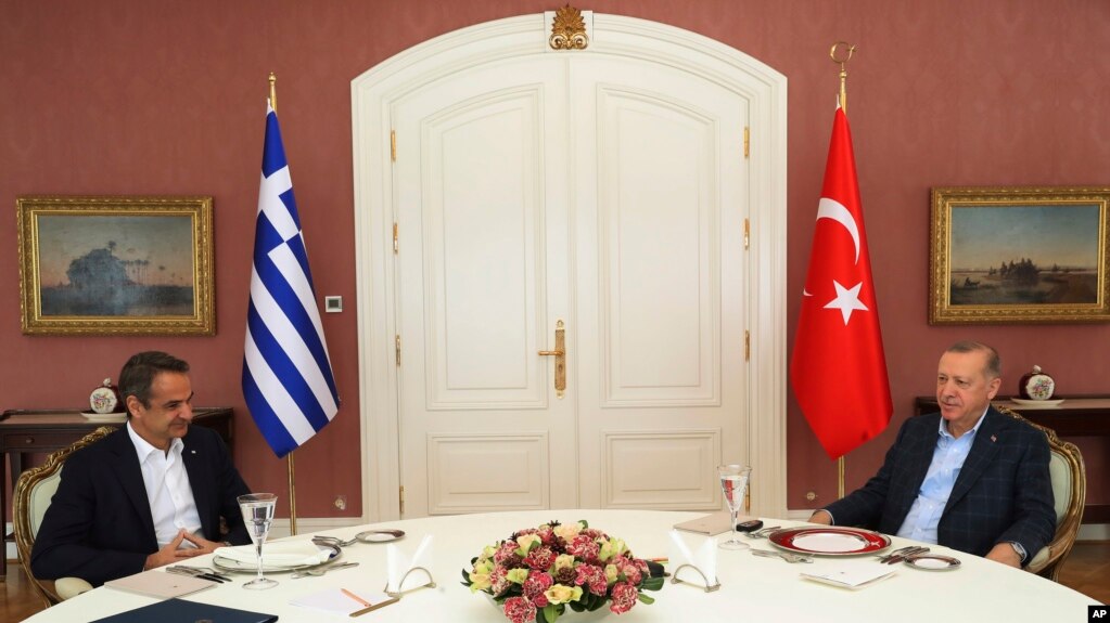 FILE - In this photo provided by the Turkish Presidency, Greek Prime Minister Kyriakos Mitsotakis, left, is seen with Turkish President Recep Tayyip Erdogan during their meeting in Istanbul, Turkey,March 13, 2022. 
