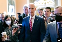 Senator Rick Scott, R-Fla., is surrounded by reporters at the Capitol in Washington, Nov. 16, 2022.