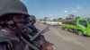 In this image made from video, Rwandan police patrol a road in Palma, Cabo Delgado province, Mozambique, Aug. 15, 2021. A new offensive by Mozambique's Islamic extremist rebels in Cabo Delgado has increased the number of displaced by 80,000 and undermines