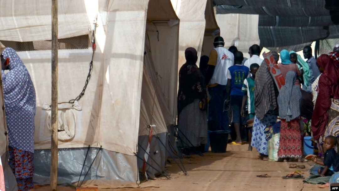 FILE - People line up at a makeshift health clinic treating patients suffering from meningitis, in Lazaret, near Niamey, Niger, April 23, 2015.