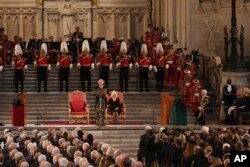 King Charles III gives his address as Camilla, the Queen Consort listens, in Westminster Hall, where both Houses of Parliament met to express their condolences, following the death of Queen Elizabeth II, in London, Sept. 12, 2022.