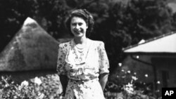 Queen Elizabeth II, then Princess Elizabeth, poses for her 21st birthday release picture, during a three day rest in the Natal National Park in South Africa on April 11, 1947. (AP Photo)