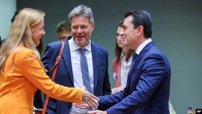 European Commissioner for Energy Kadri Simson, left, greets Greek Energy Minister Constantinos Skrekas, right, and Germany's Energy Minister Robert Habeck, center, during a meeting of EU energy ministers in Brussels, Friday, Sept. 9, 2022. (AP Photo/Olivier Matthys)