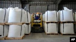 Shipping trainee Keenan Kinder uses a forklift to move large bags of lithium carbonate at Albemarle Corp.'s Silver Peak lithium facility, Thursday, Oct. 6, 2022, in Silver Peak, Nev. The Biden administration on Wednesday, Oct. 19, awarded $2.8 billion in 