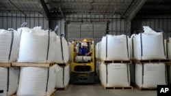 With a forklift, Keenan Kinder moves bags of lithium carbonate in Silver Peak, Nevada, Oct. 6, 2022. Authorities in Botswana are reporting increased thefts of lithium batteries from mobile phone towers amid a surge in global demand for the battery in electric vehicles.