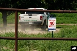 A Border Patrol vehicle enters Heavenly Farms, a pecan farm owned by Hugo and Magali Urbina, Friday, Aug. 26, 2022, in Eagle Pass, Texas. The area has become entangled in a turf war between the Biden administration and Texas Gov. Greg Abbott over how to police the U.S. border with Mexico. (AP Photo/Eric Gay)