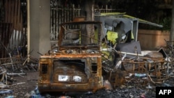 FILE - A burned car and building are seen in Shashamene, Oromia region, Ethiopia, July 12, 2020, after protests and ethnic violence.