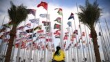 A woman sits at Flags square, in Doha, ahead of the Qatar 2022 World Cup football tournament. 