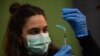 FILE - A medical staff member prepares a Pfizer vaccine during a COVID-19 vaccination campaign in Pamplona, northern Spain, on March 16, 2021. 