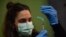 FILE - A medical staff member prepares a Pfizer vaccine during a COVID-19 vaccination campaign in Pamplona, northern Spain, on March 16, 2021. 