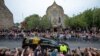 Members of the public gather on the Royal Mile at Cannongate Kirk to watch the hearse carrying the coffin of Britain's Queen Elizabeth, draped with the Royal Standard of Scotland, as it completes its journey from Balmoral to the Palace of Holyroodhouse in