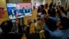 Members of the Cambodian media take pictures of a screen telecasting an address by U.S. President Joe Biden during the ASEAN Summit, from a live feed video at the media center in Phnom Penh, Nov. 13, 2022.