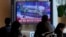A TV screen shows a file image of a North Korean missile in a military parade during a news program at the Seoul Railway Station in Seoul, South Korea, Nov. 18, 2022. South Korea said a missile North Korea launched Friday morning was likely an intercontinental ballistic missile.