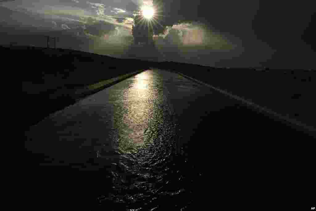 FILE - Water flows along the All-American Canal, Aug. 13, 2022, near Winterhaven, Calif. 