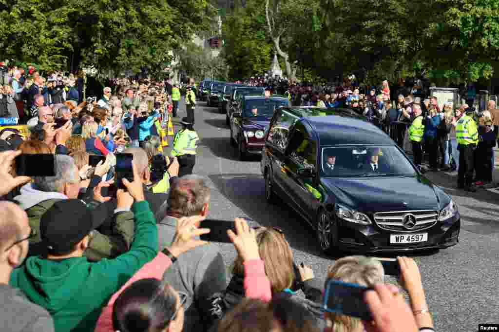 The hearse carrying the coffin of Britain's Queen Elizabeth passes through the village of Ballater, near Balmoral, Scotland, Sept. 11, 2022.