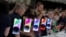 Guests look at the new iPhone 14 at an Apple event at its headquarters in Cupertino, Calif., Sept. 7, 2022.