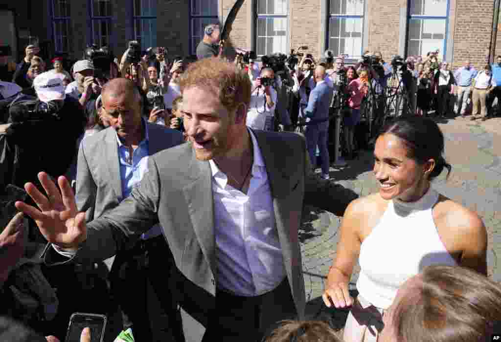 Britain&#39;s Prince Harry, left, and Meghan, Duchess of Sussex, meet people after a visit at the town hall in Duesseldorf, Germany.&nbsp;Prince Harry visits the city as ambassador for the Invictus games, a week-long games for active servicemen and veterans who are ill, injured or wounded, held in Duesseldorf next year.