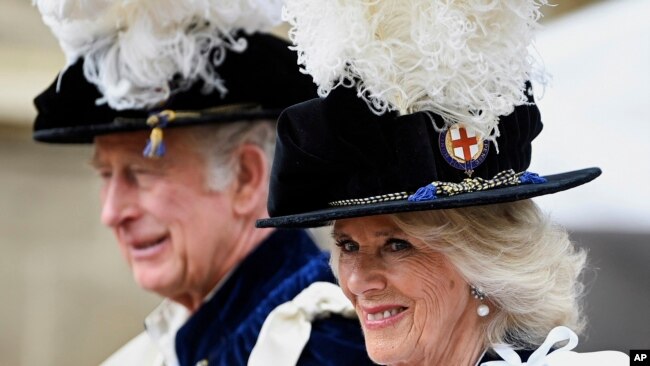 FILE - Britain's Prince Charles and Camilla, Duchess of Cornwall arrive for the Order of the Garter service at Windsor Castle, in Windsor, England, June 13, 2022.